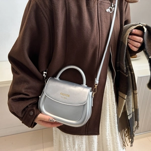 Chic metallic silver saddle bag for women with top handle and adjustable shoulder strap