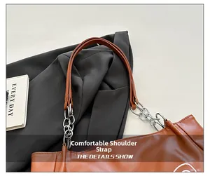 Detail of leather strap with silver chain links on a caramel brown tote bag