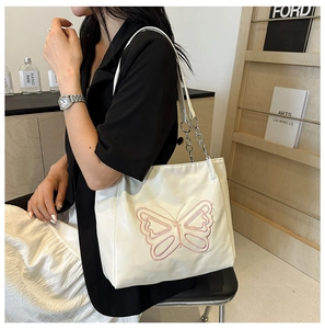 White shoulder tote bag with pink butterfly embroidery and chain strap for women