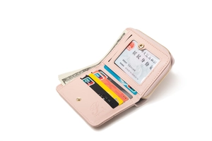 Detail of light pink women's short wallet showing inner card slots and photo window