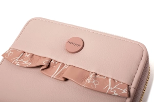 Detail of pink Prettyzys wallet featuring scalloped edges and floral leather texture