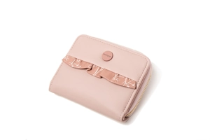 Close-up of pink PU leather wallet with floral bow detail and secure zipper closure