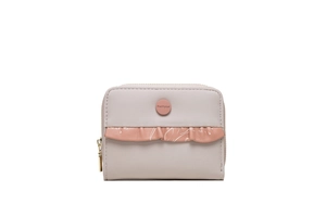Close-up of short zip wallet featuring pink ruffled lace trim and gold metal hardware