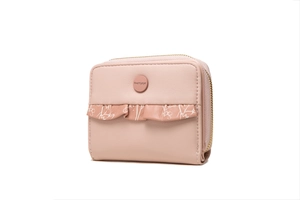 Detail view of the pink faux leather wallet featuring floral ruffles and a zip closure