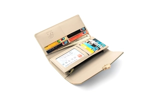 Interior detail of a long wallet with card slots and golden cat buckle in beige