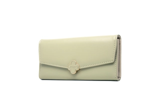Close-up of light green long leather wallet with gold clover clasp and precision stitching