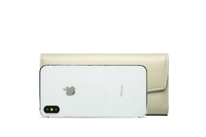 Detailed view of beige long trifold wallet featuring lychee pattern leather and snap button