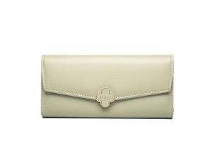 Close-up of pale green long wallet with clover metal clasp and lychee leather texture