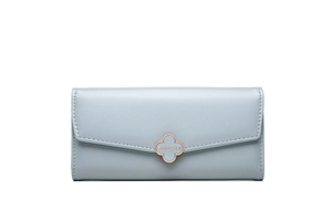 Detailed macro of the rose gold clover buckle and lychee texture on the blue long wallet