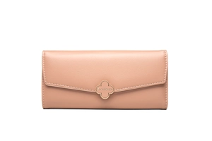 Macro detail of nude long wallet featuring a golden clover buckle and textured finish