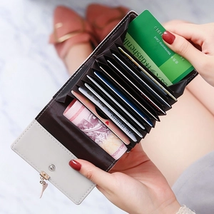 Light gray accordion card holder with leaf pendant and multi-slot functional storage