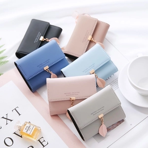 Short PU leather card holder wallets with leaf pendants in six colors on white background