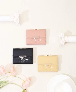 Detailed close-up of floral print PU leather wallets with elegant metal brand plaque