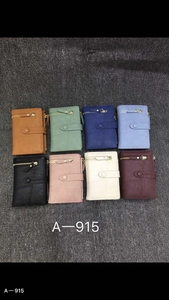 Flat lay of multiple multi-colored PU leather long wallets with zippers and snap closures