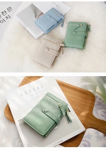 Detailed view of women's matte PU leather short folding wallets in soft pastel tones