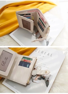 Interior detail of a compact beige wallet showing card slots, photo ID window and coin pouch