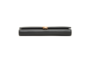 Close-up of slim black leather wallet showing triple-layer structure and gold buckle