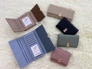 Detail of colorful quilted PU leather wallets with clover metal buckles and multiple card slots