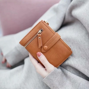 Classic brown short leather wallet with zipper and snap closure shown in hand