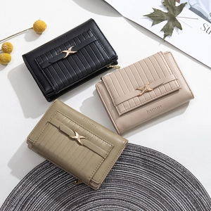 Three Prettyzys short leather wallets with elegant vertical grain and gold X-shaped buckles