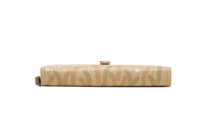 Detail of floral print on long beige wallet with metal clasp and leather texture