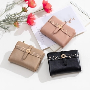 Three-color floral detail view of small PU leather wallets with gold hardware rings