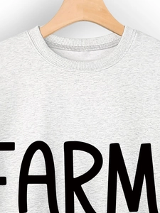 Close-up of Farm Girl crew neck sweatshirt fabric texture and black letter printing