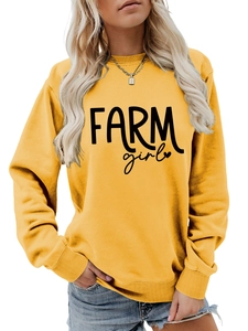 Detail of Farm Girl letter print and ribbed cuffs on yellow crewneck sweatshirt