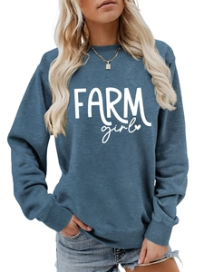 Close-up of Farm Girl print and ribbed crewneck on a vintage blue sweatshirt