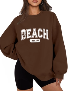 Detail of BEACH THERAPY letter print and palm tree graphics on brown long sleeve sweatshirt