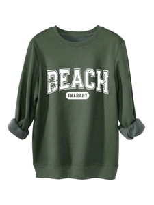 Detail of dark green sweatshirt showing soft grey fleece lining on the sleeve cuff