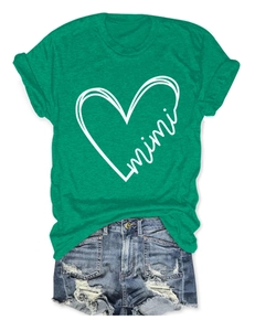 Detail of green mimi heart print t-shirt tucked into frayed denim shorts