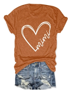 Detail of rust red t-shirt with mimi heart print and distressed denim shorts
