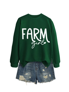 Detail of dark green crewneck sweatshirt with Farm Girl text and distressed denim shorts
