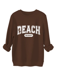 Detail of Beach Therapy print on brown long sleeve sweatshirt with ribbed cuffs