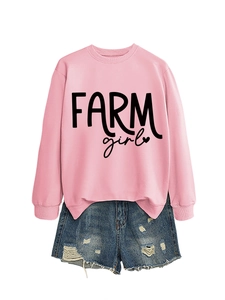 Detail view of pink long sleeve sweatshirt with Farm Girl text and distressed denim shorts