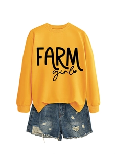 Detailed flat lay of a yellow Farm Girl sweatshirt and distressed denim shorts outfit