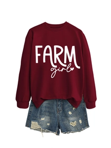 Close-up of Farm Girl screen print on burgundy sweatshirt paired with denim shorts