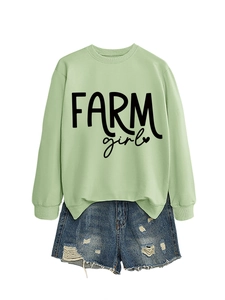Flat lay of a sage green Farm Girl sweatshirt paired with distressed blue denim shorts