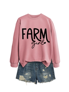 Detail of pink crewneck sweatshirt with black Farm Girl text and casual denim shorts