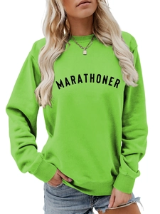 Detail of MARATHONER text print on neon green sweatshirt with ribbed cuffs and crew neck