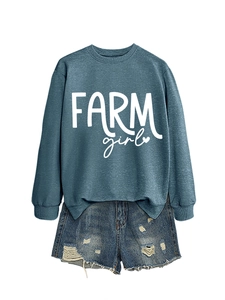 Detail of Farm Girl sweatshirt paired with distressed denim shorts on white background