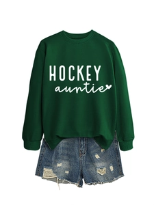 Détail du sweat vert foncé hockey auntie avec un short en jean délavé à franges