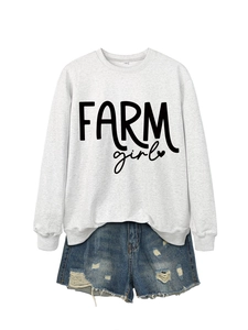 Flat lay of a grey crewneck sweatshirt with FARM girl print and distressed denim shorts