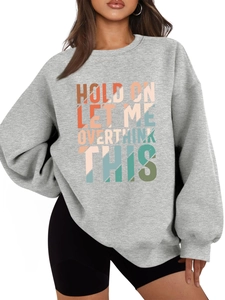 Detail of grey sweatshirt showing colorful gradient text print on soft knitted fabric