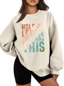 Detail of the colorful retro lettering on this oversized cream crewneck sweatshirt
