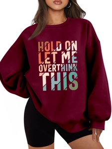 Detail of burgundy oversized sweatshirt featuring vintage 'HOLD ON LET ME OVERTHINK THIS' print
