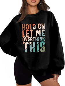 Detail of colorful HOLD ON LET ME OVERTHINK THIS text on black oversized sweatshirt