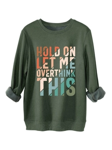 Close-up of thick fleece lining and ribbed cuffs on a dark green crewneck sweatshirt