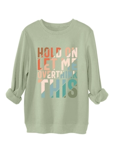 Detail of sage green sweatshirt with Hold On Let Me Overthink This colorful text